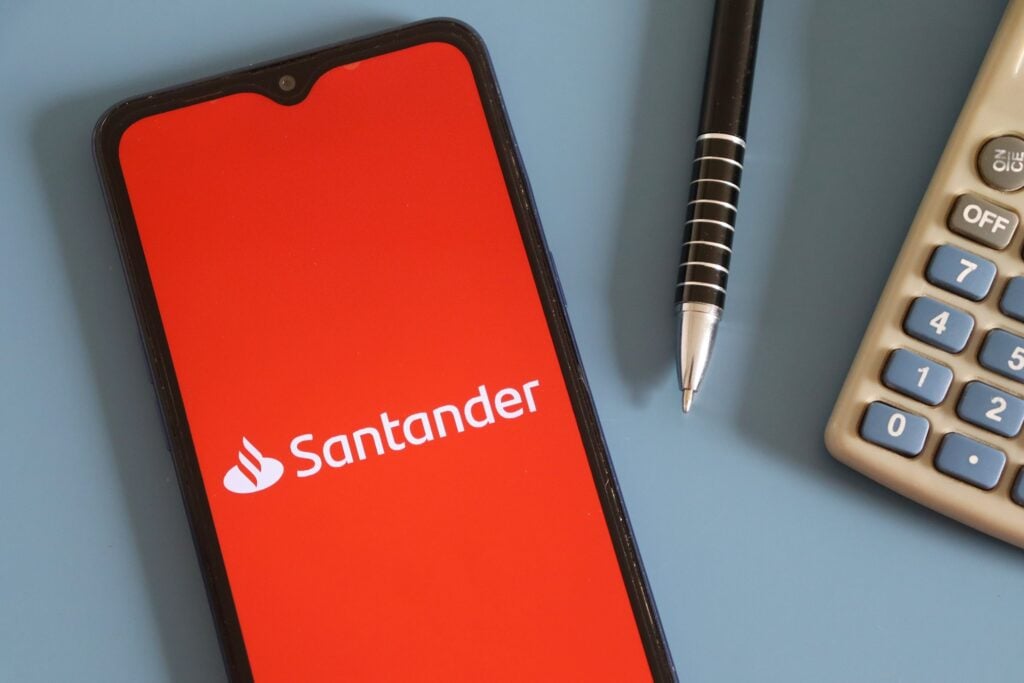 Bahia, Brazil - June 16, 2022: Banco Santander (Santander Bank) logo on smartphone screen on office desk.